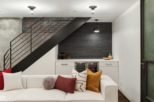 living area featuring wine cooler and stairway