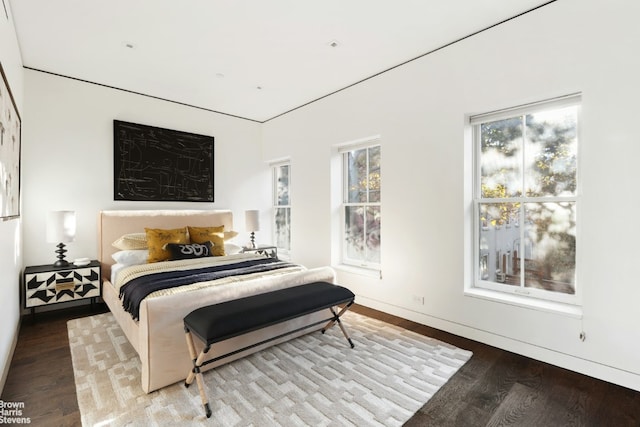 bedroom with light wood-type flooring and baseboards