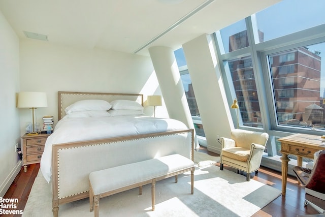 bedroom with wood finished floors and baseboards