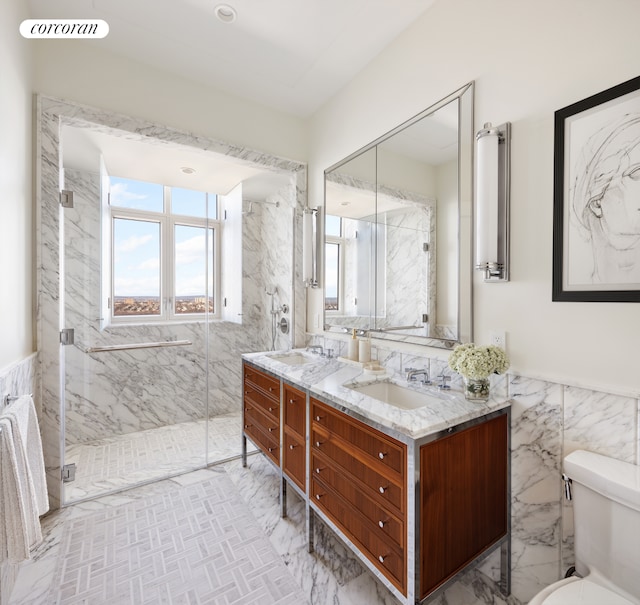 100 Claremont Ave Unit 36B, New York City, NY 10027 - bathroom featuring double vanity, a marble finish shower, tile walls, and toilet