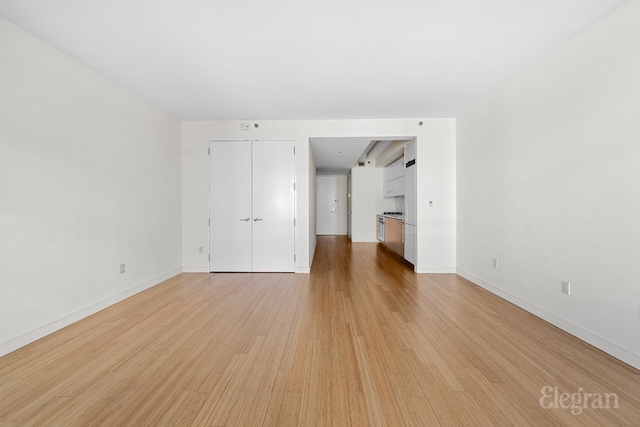 spare room with light hardwood / wood-style flooring