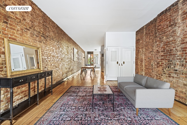 215 E 17th St Unit 3, New York City, NY 10003 - living area featuring hardwood / wood-style floors and brick wall