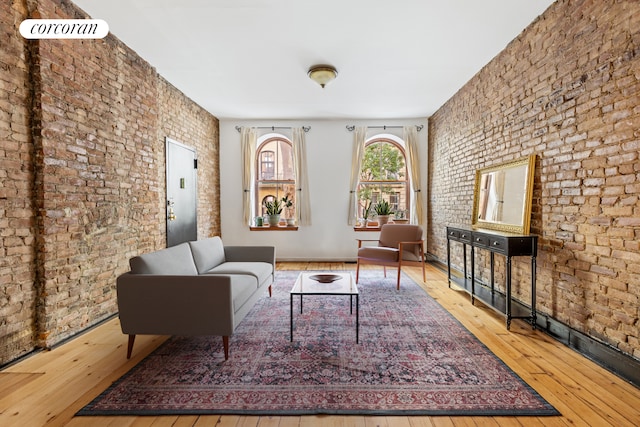 215 E 17th St Unit 3, New York City, NY 10003 - sitting room featuring brick wall and wood-type flooring