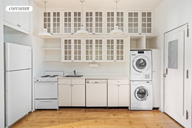 215 E 17th St Unit 3, New York City, NY 10003 - kitchen with white appliances, stacked washer / dryer, open shelves, and white cabinets