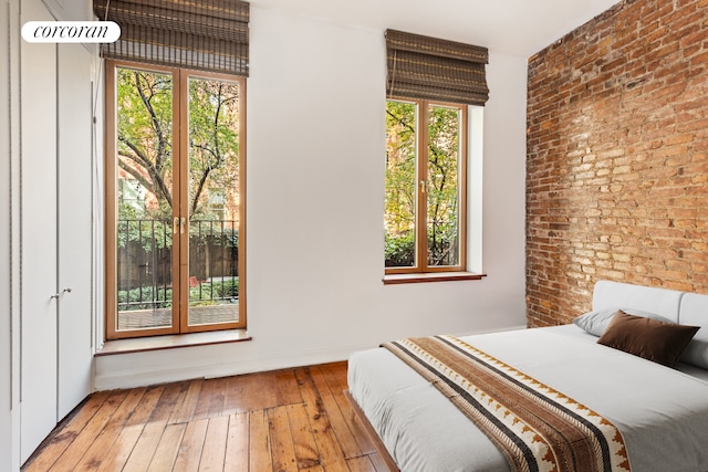 215 E 17th St Unit 3, New York City, NY 10003 - bedroom with hardwood / wood-style flooring and brick wall
