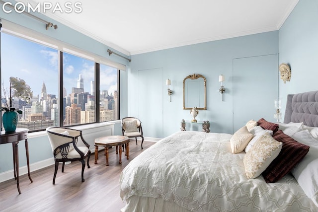 bedroom with wood-type flooring, crown molding, and multiple windows