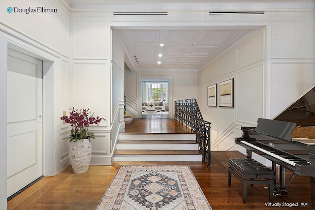 6 E 69th St, New York City, NY 10021 - entrance foyer featuring a decorative wall, crown molding, stairway, and wood finished floors