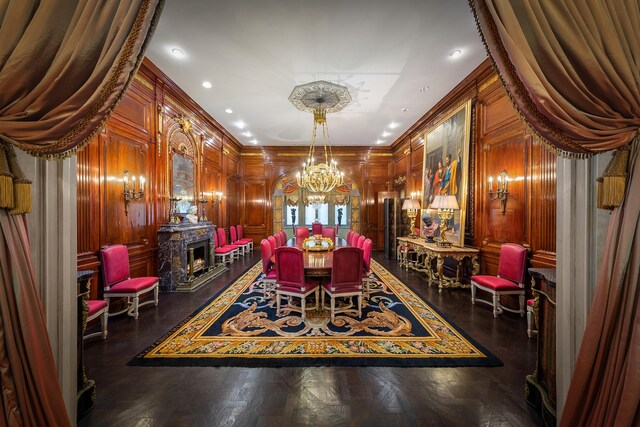 4 E 80th St, New York City, NY 10075 - dining space with wooden walls, a notable chandelier, recessed lighting, a lit fireplace, and ornamental molding