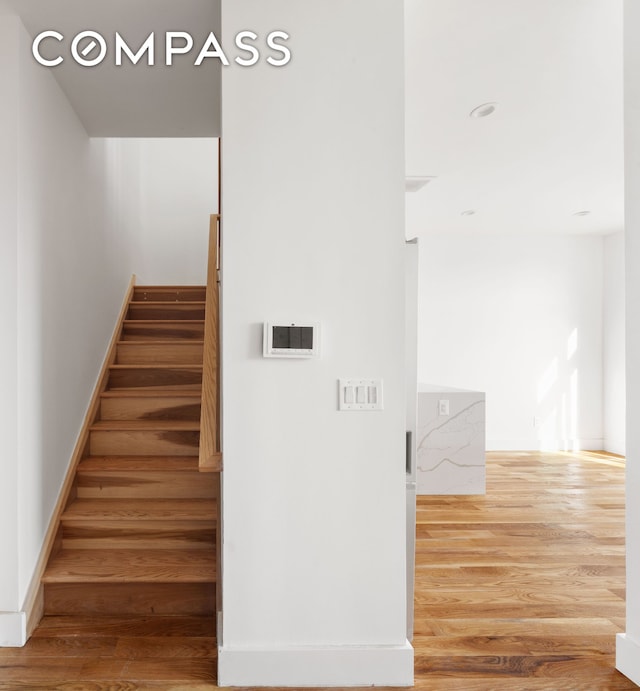 stairs featuring baseboards and wood finished floors