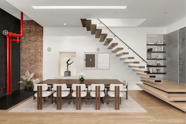 dining space with stairs and wood finished floors