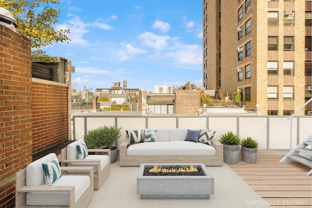 balcony with an outdoor living space with a fire pit