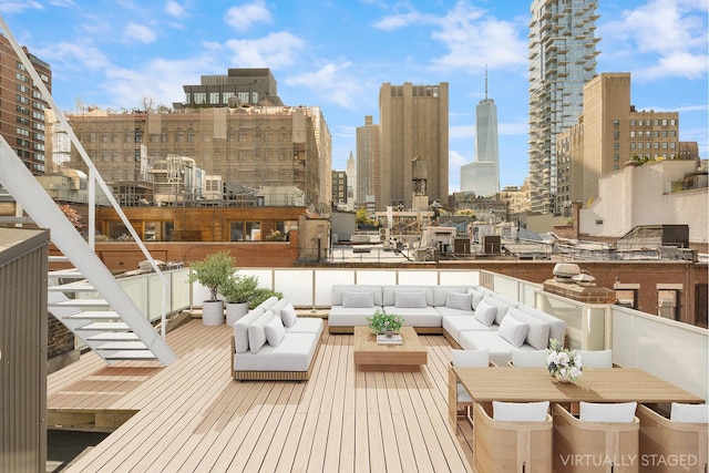 wooden terrace with an outdoor hangout area and a view of city