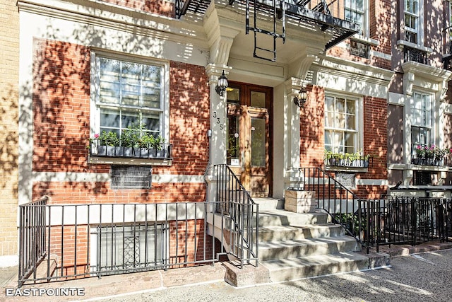 doorway to property with brick siding