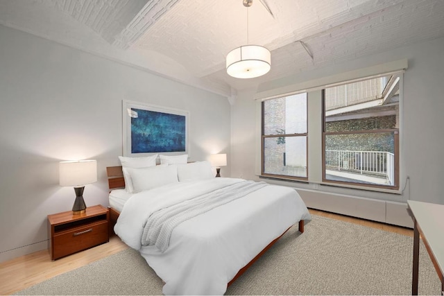 bedroom featuring brick ceiling and light wood-type flooring