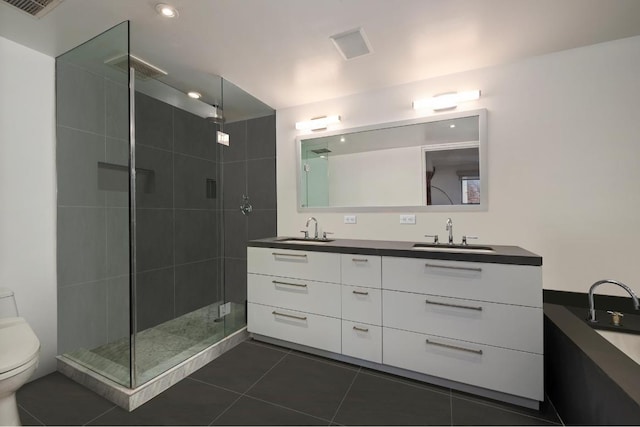 bathroom with an enclosed shower, vanity, tile patterned floors, and toilet