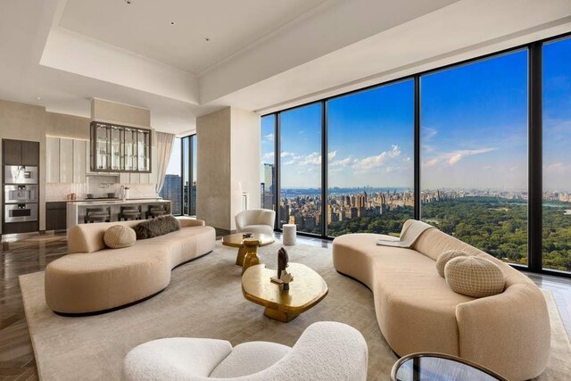 living room with floor to ceiling windows and a healthy amount of sunlight