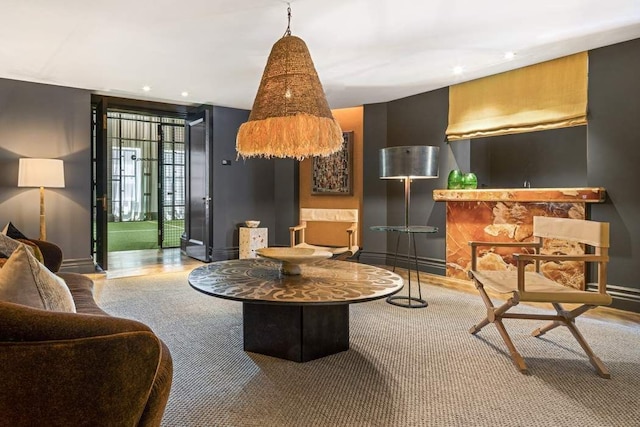 living room featuring a wall of windows and a fireplace