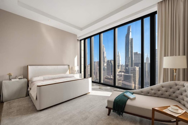 carpeted bedroom featuring floor to ceiling windows