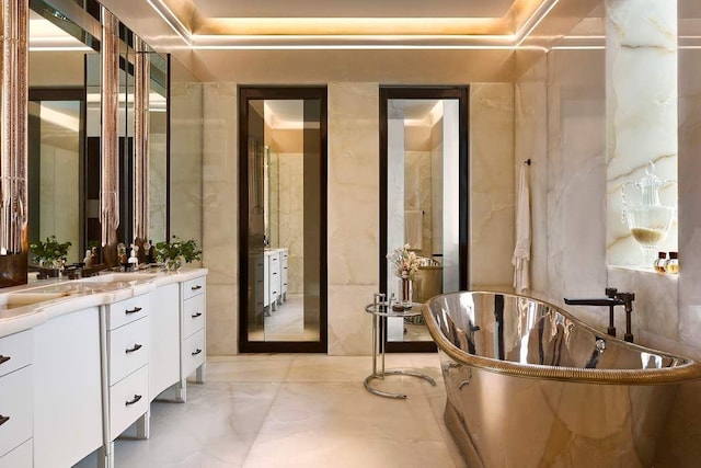 bathroom with vanity and a bath