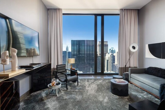 carpeted living room with floor to ceiling windows