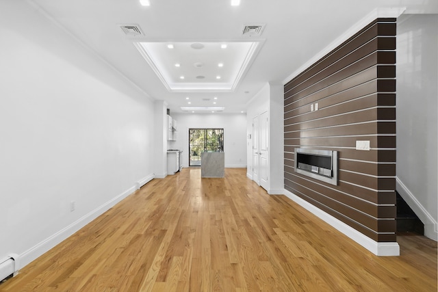 1241 Herkimer St, New York City, NY 11233 - unfurnished living room with light wood-style floors, a raised ceiling, a fireplace, recessed lighting, and a baseboard radiator