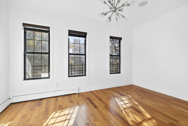 unfurnished room with a wealth of natural light, baseboard heating, and wood finished floors