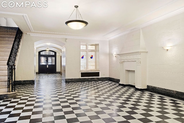 entrance foyer featuring ornamental molding and french doors