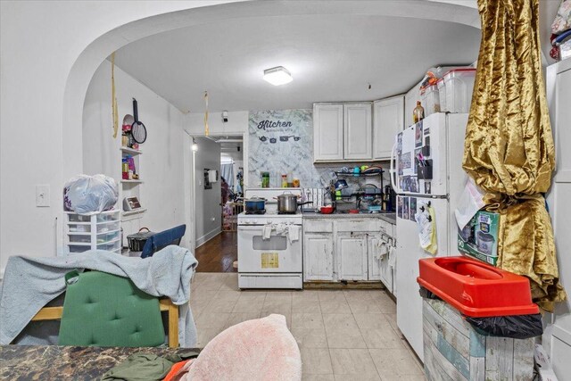 kitchen with white appliances and white cabinets