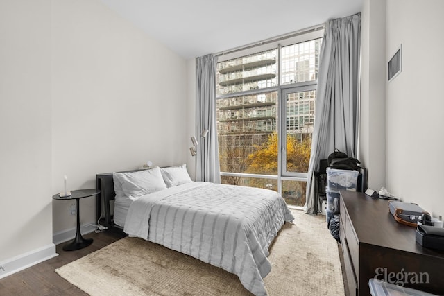 bedroom with dark hardwood / wood-style floors