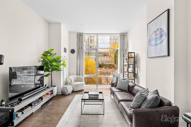 living area with a wall of windows and hardwood / wood-style floors