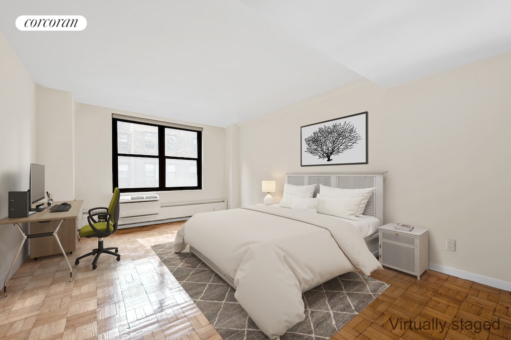 bedroom with a baseboard heating unit, visible vents, and baseboards