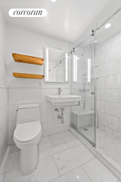 bathroom featuring tile walls, an enclosed shower, and toilet