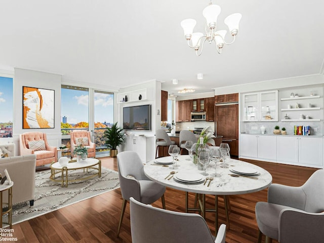 dining area with a chandelier and wood finished floors