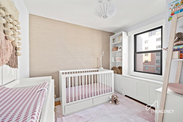 bedroom featuring a nursery area