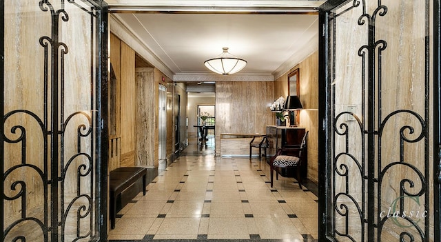 hall with ornamental molding and wooden walls