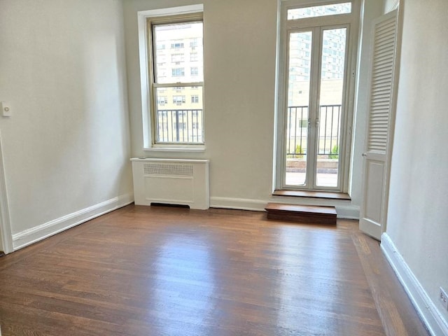 interior space with radiator and dark wood-type flooring