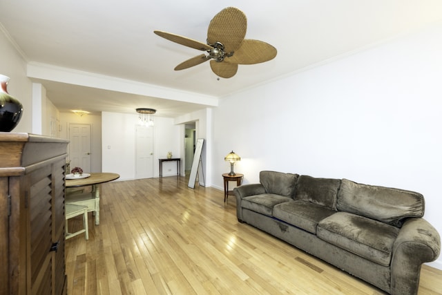 living room featuring crown molding, ceiling fan, and light wood-type flooring