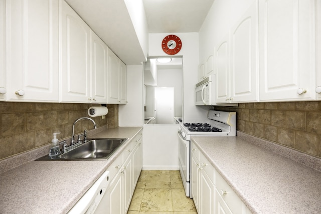 kitchen featuring tasteful backsplash, sink, white cabinets, and white appliances