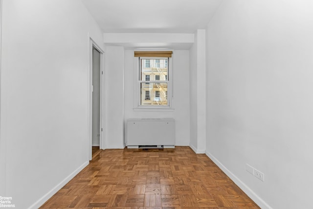 empty room with radiator and baseboards