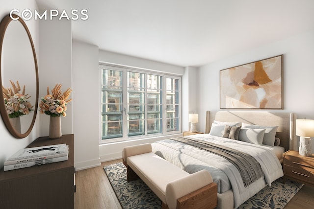 bedroom featuring light wood-type flooring and baseboards