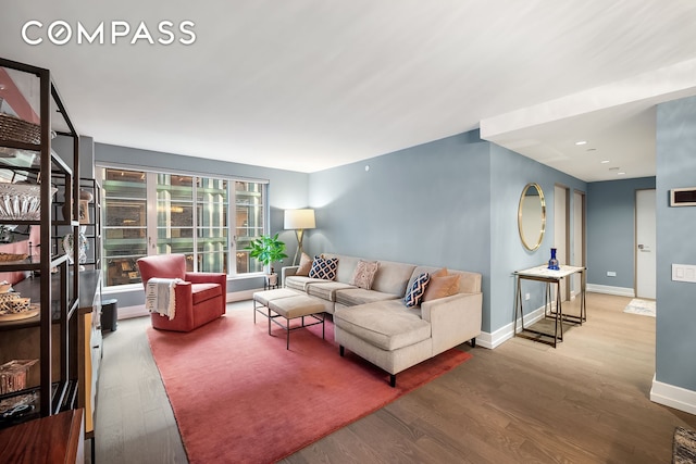 living room featuring baseboards and wood finished floors