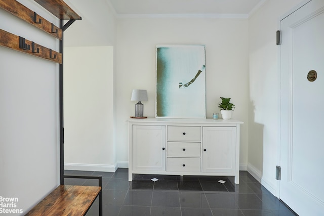 interior space with vanity, crown molding, and tile patterned floors