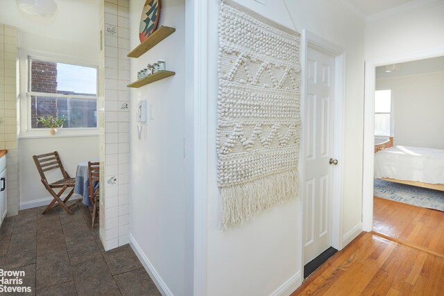 hallway with dark wood-style flooring and baseboards