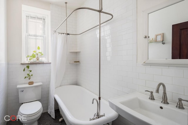 full bathroom featuring tile walls, sink, toilet, and shower / bath combo with shower curtain