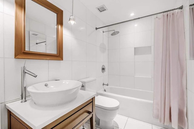 full bathroom with tile patterned flooring, vanity, tile walls, toilet, and shower / tub combo with curtain