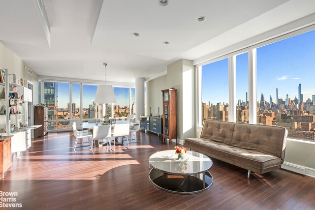 living room featuring expansive windows, plenty of natural light, and dark hardwood / wood-style floors