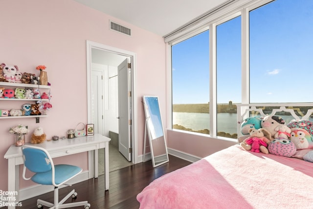 bedroom with baseboards, visible vents, and dark wood-style flooring