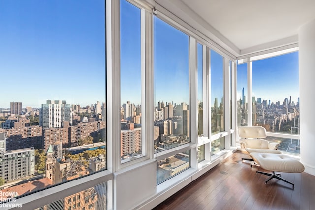 sunroom featuring a view of city and a healthy amount of sunlight