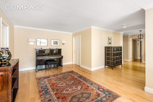 interior space featuring wood finished floors, baseboards, and ornamental molding