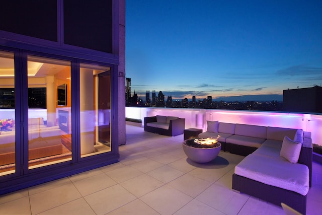 view of patio with an outdoor living space with a fire pit